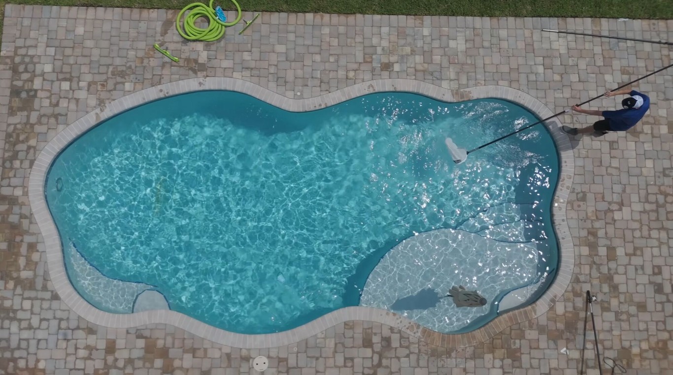 Professional weekly pool cleaning service in Cibolo, TX showing crystal clear pool water